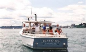 White & Blue hulled lobster boat with smiling crew aboard