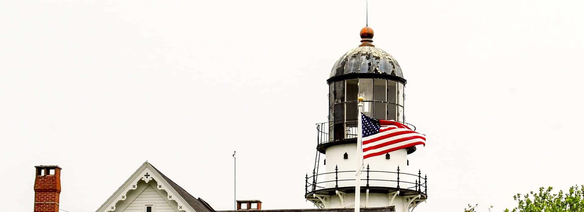 Top section of old lighthouse painted white with black steal