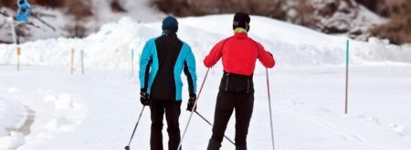 Two people cross country skiing