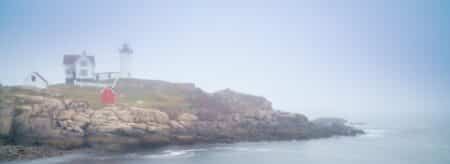 view of cape neddick on nubble island on a foggy day