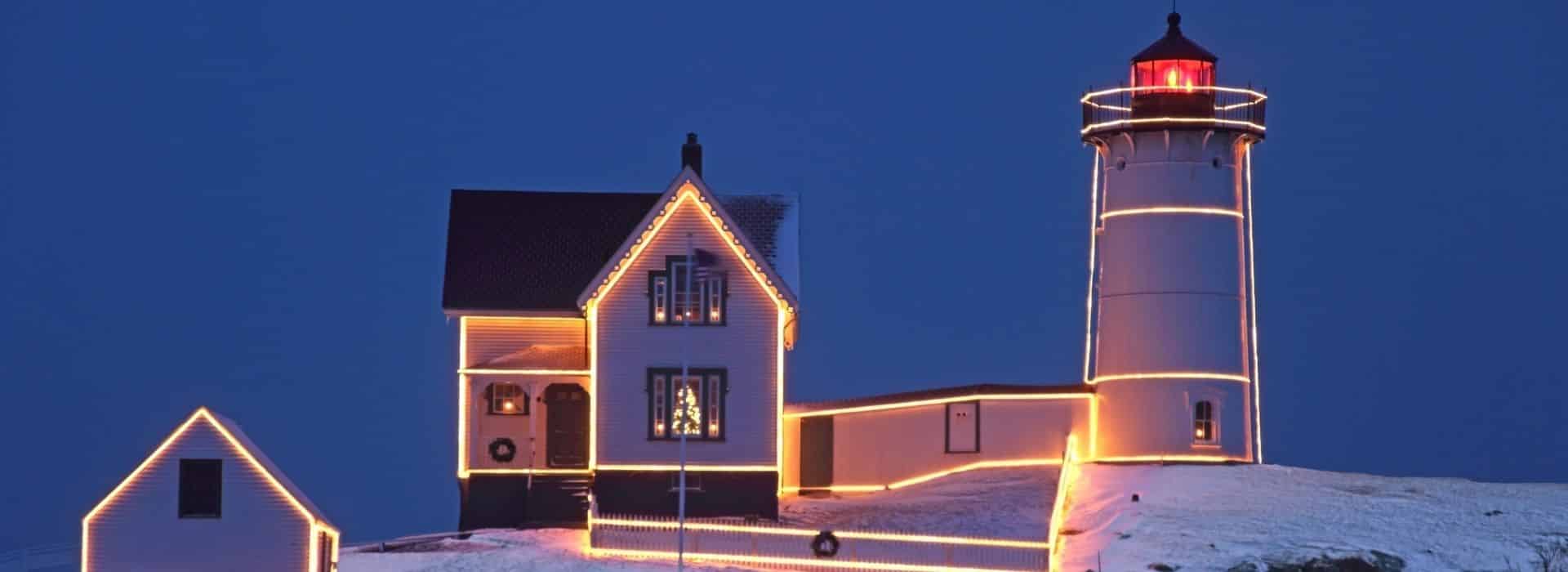 cape neddick lighthouse lit up with christmas lights for the holidays