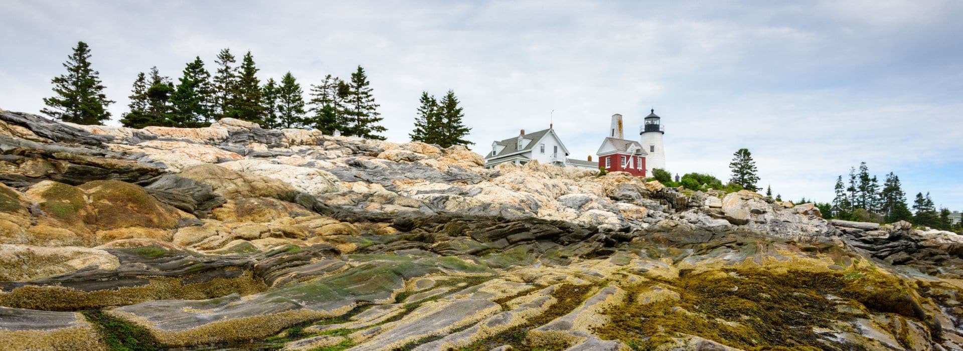 view of rocky coastline and pemaquid point lighthouse