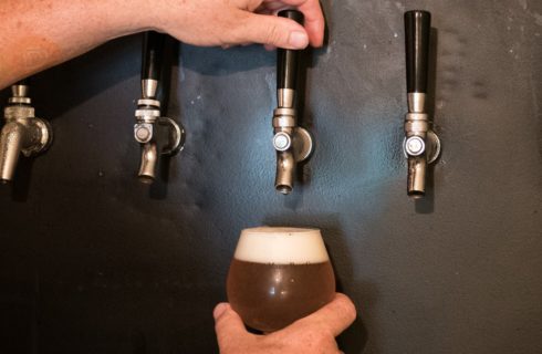 Close up view of beer being poured from a tap