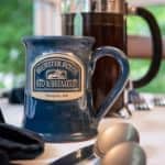 Close up view of Brewster House Bed & Breakfast blue stoneware mug