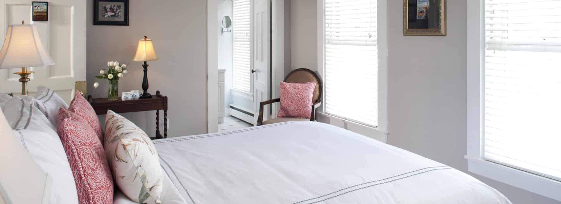 Bright and inviting guest room at Brewster House Bed & Breakfast in Freeport, Maine, featuring elegant décor and natural light