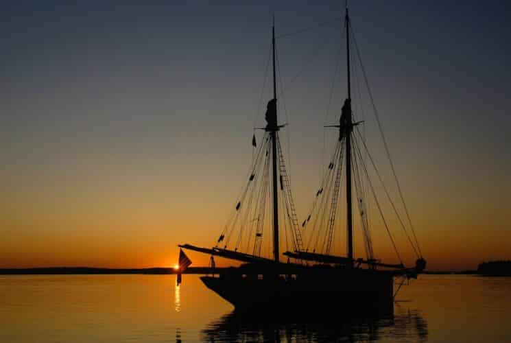 Large sailing ship on the water as the sun sets